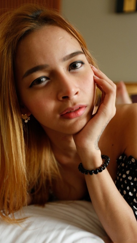Pretty Asian shemale Yuki poses in her top & jeans before unveiling her tits
