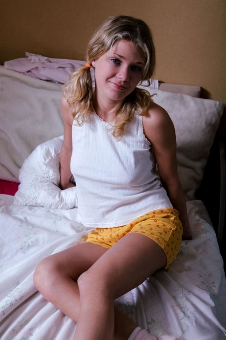 Glamorous babe Valya toys her yummy pussy after a sexy striptease on her bed
