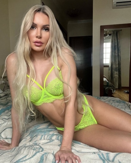Glamorous blonde teases with her big tits in sexy lingerie on her bed