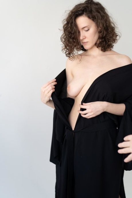 Gorgeous curly haired petite babe shows her beautiful tits while topless