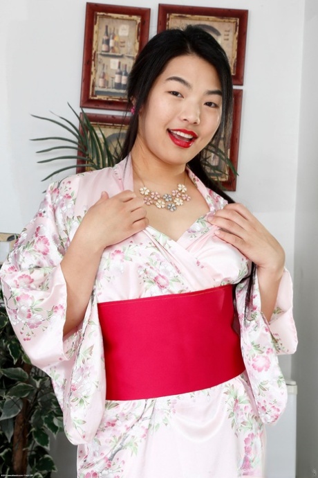 Asian honey Nari Park exposes her bushy twat and poses naked in a solo